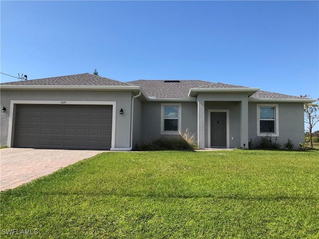 ranch-style house featuring a garage and a front yard