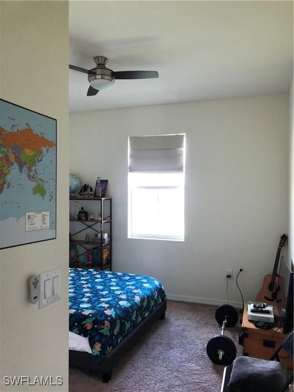 bedroom featuring ceiling fan and carpet