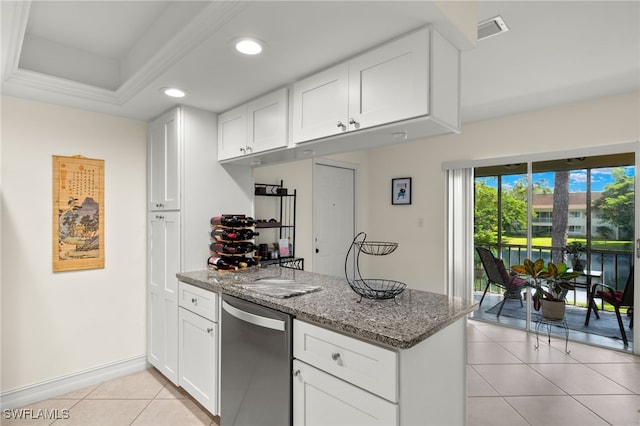 kitchen with visible vents, white cabinetry, light tile patterned flooring, dark stone counters, and a peninsula