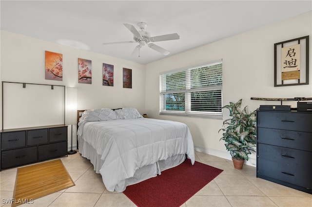 bedroom featuring light tile patterned floors, baseboards, and a ceiling fan