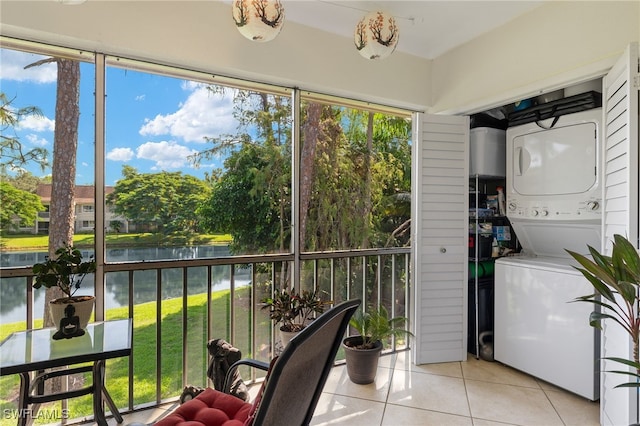 sunroom with a water view and stacked washing maching and dryer