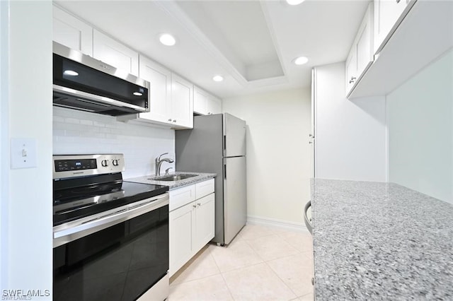 18 Bob O Link Ct Unit 18B, Naples, FL 34105 - kitchen with stainless steel appliances, backsplash, white cabinetry, recessed lighting, and light stone counters