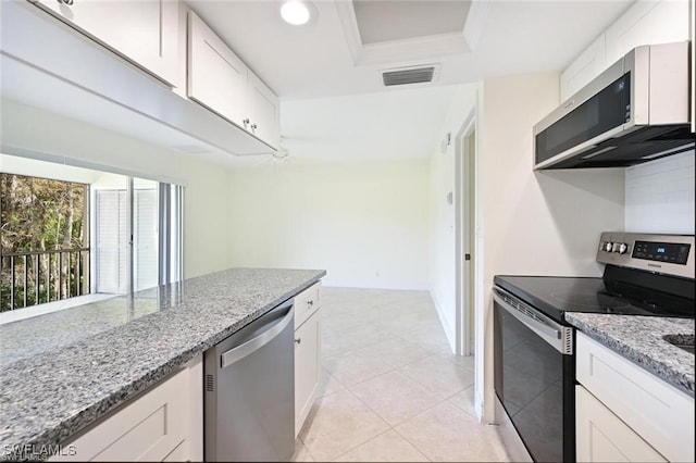 18 Bob O Link Ct Unit 18B, Naples, FL 34105 - kitchen featuring stainless steel appliances, light stone counters, white cabinets, and a tray ceiling