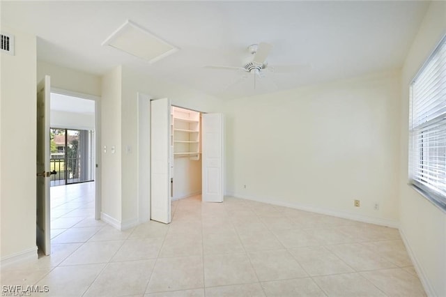 18 Bob O Link Ct Unit 18B, Naples, FL 34105 - unfurnished bedroom featuring attic access, light tile patterned floors, a spacious closet, a ceiling fan, and a closet