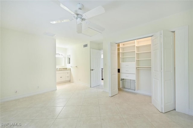 18 Bob O Link Ct Unit 18B, Naples, FL 34105 - unfurnished bedroom with light tile patterned floors, a ceiling fan, ensuite bath, and a walk in closet