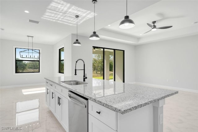 kitchen with dishwasher, a raised ceiling, sink, decorative light fixtures, and white cabinetry