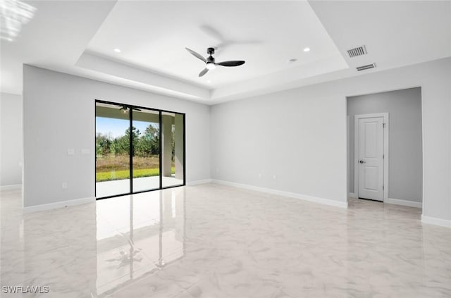 unfurnished room with a tray ceiling and ceiling fan