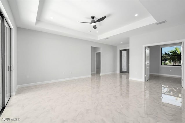 interior space featuring a tray ceiling and ceiling fan