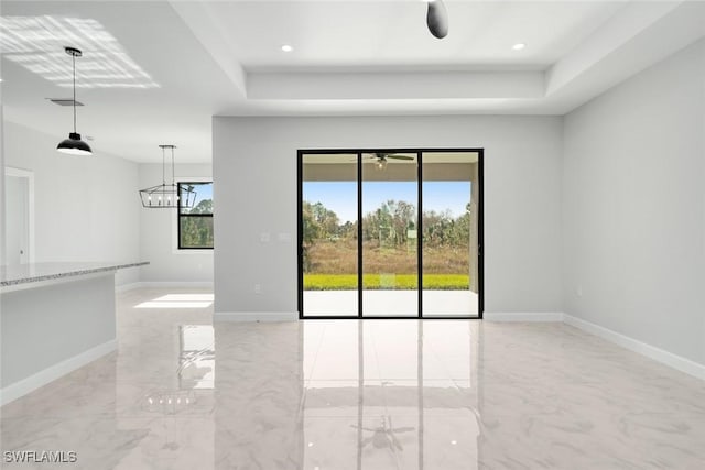 spare room featuring a raised ceiling