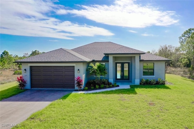 view of front of house with a front lawn, a garage, and french doors