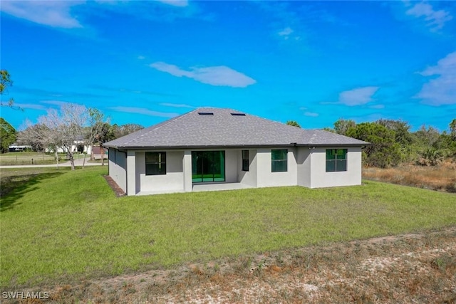 rear view of house featuring a lawn and a patio area