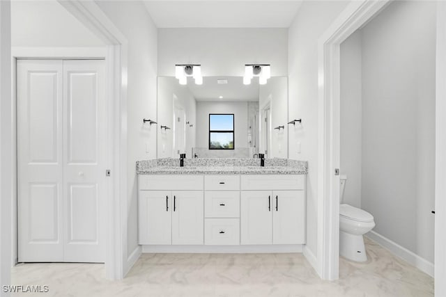 bathroom featuring vanity and toilet