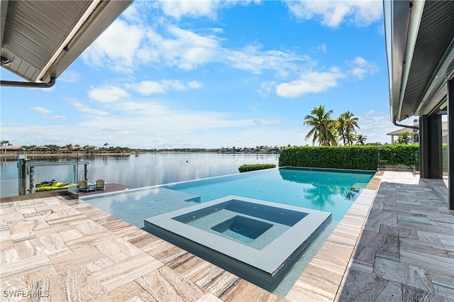 view of swimming pool featuring an in ground hot tub, a water view, and a patio