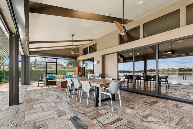 view of patio with ceiling fan, a water view, and an outdoor hangout area