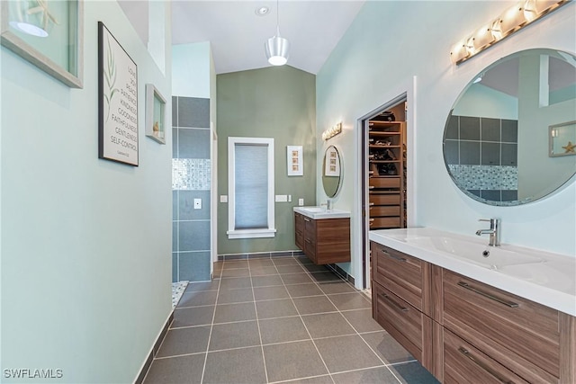 bathroom with vanity, a shower, and tile patterned floors