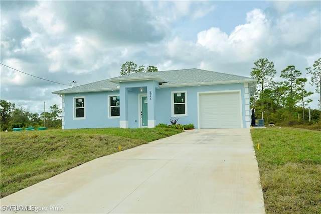 view of front of home with a garage and a front lawn