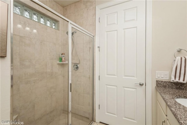 bathroom featuring a shower stall and vanity