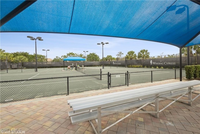 view of sport court featuring fence