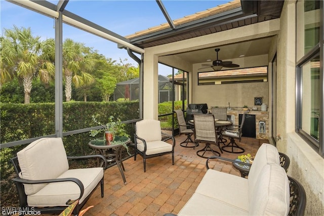 sunroom / solarium featuring plenty of natural light and ceiling fan