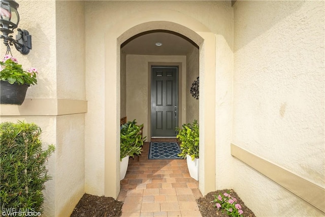 doorway to property with stucco siding