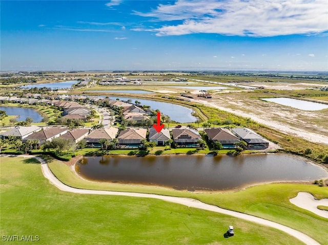 drone / aerial view featuring a water view, a residential view, and golf course view