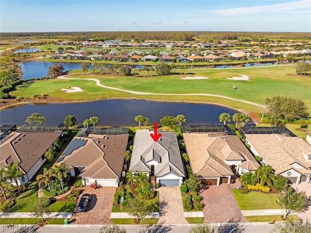 bird's eye view with a water view, view of golf course, and a residential view