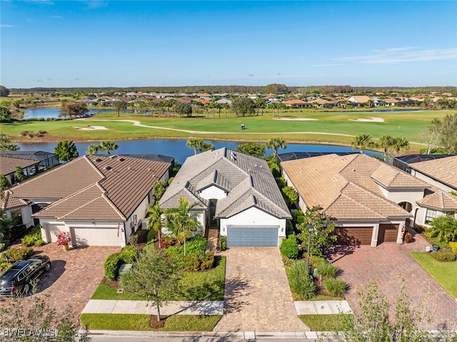 bird's eye view with a water view, view of golf course, and a residential view