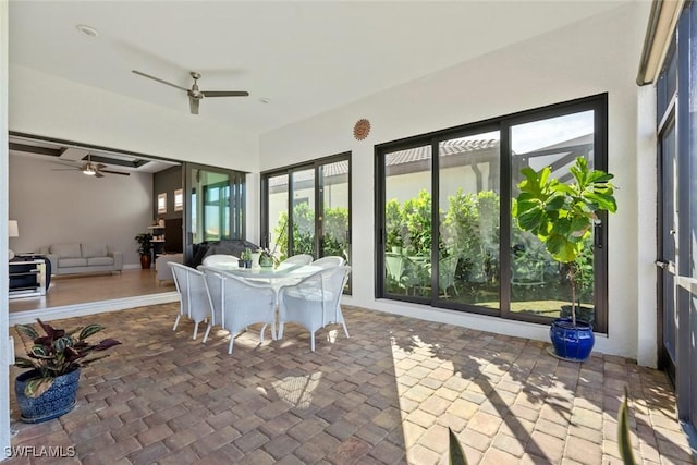 unfurnished sunroom with ceiling fan and french doors