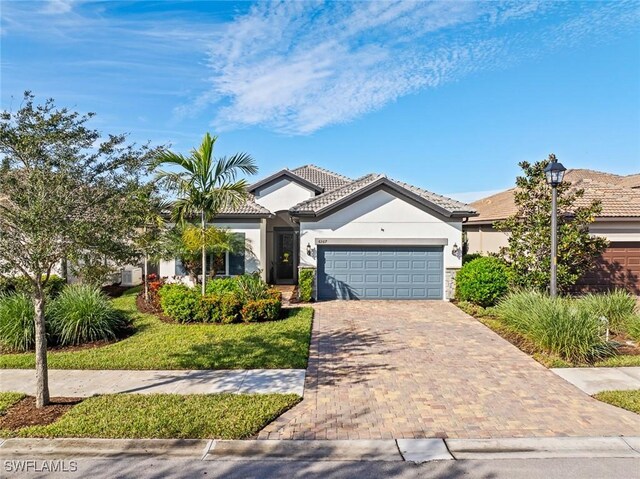 view of front facade featuring a front yard and a garage