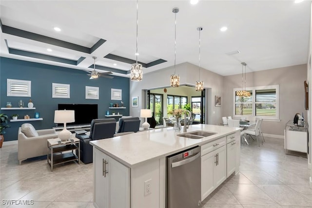 kitchen featuring a center island with sink, hanging light fixtures, stainless steel dishwasher, open floor plan, and white cabinetry