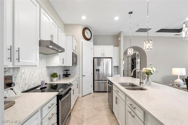 kitchen featuring under cabinet range hood, stainless steel appliances, a sink, white cabinets, and decorative light fixtures