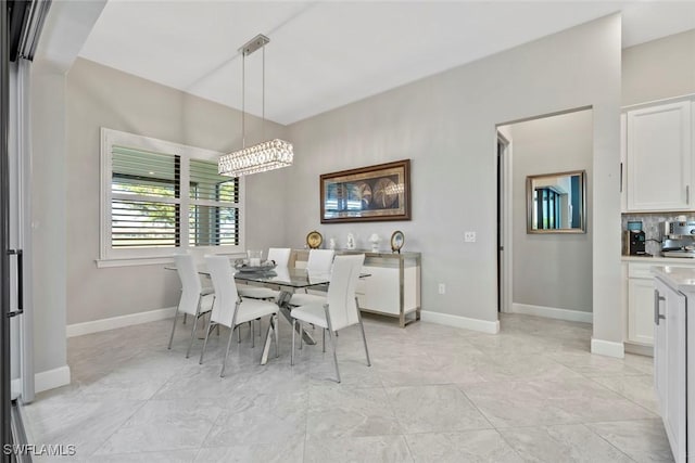 dining space featuring baseboards