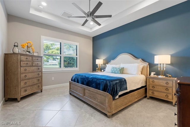 bedroom featuring baseboards, a ceiling fan, a tray ceiling, light tile patterned flooring, and recessed lighting