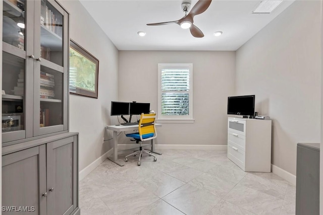 home office with a ceiling fan, visible vents, and baseboards