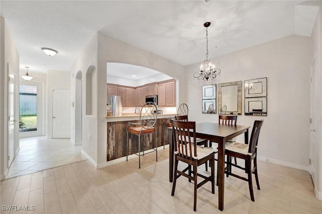 4350 Lazio Way Unit 1102, Fort Myers, FL 33901 - dining area featuring arched walkways and a chandelier
