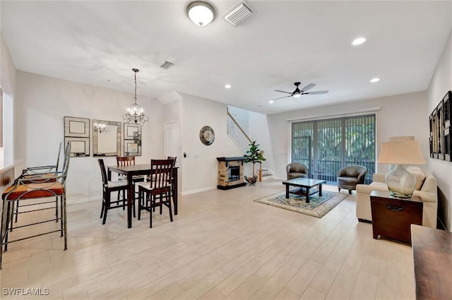 4350 Lazio Way Unit 1102, Fort Myers, FL 33901 - living area with a ceiling fan, light wood-style floors, a chandelier, recessed lighting, and stairs