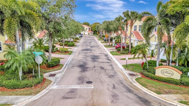 4350 Lazio Way Unit 1102, Fort Myers, FL 33901 - view of asphalt road with traffic signs, curbs, and a residential view