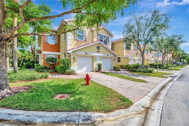4350 Lazio Way Unit 1102, Fort Myers, FL 33901 - townhome / multi-family property featuring stucco siding, decorative driveway, and a garage