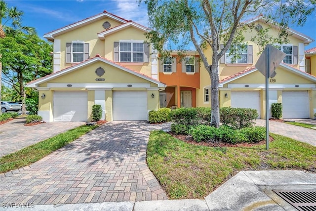 4350 Lazio Way Unit 1102, Fort Myers, FL 33901 - view of property featuring stucco siding, driveway, and an attached garage