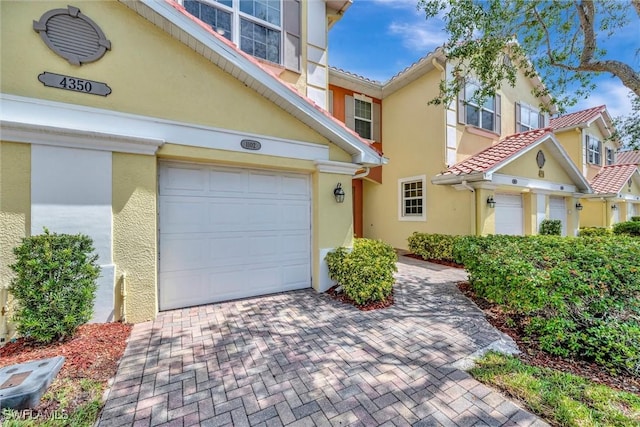 4350 Lazio Way Unit 1102, Fort Myers, FL 33901 - view of front of home featuring stucco siding, an attached garage, and a tiled roof