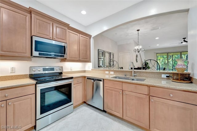 4350 Lazio Way Unit 1102, Fort Myers, FL 33901 - kitchen featuring appliances with stainless steel finishes, light brown cabinets, a chandelier, arched walkways, and recessed lighting