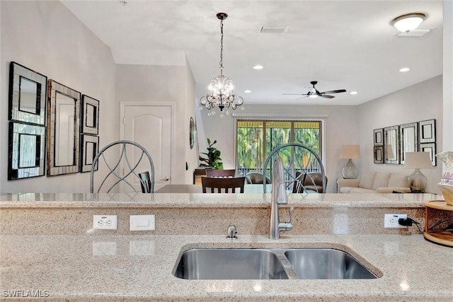 4350 Lazio Way Unit 1102, Fort Myers, FL 33901 - kitchen featuring light stone countertops, decorative light fixtures, open floor plan, recessed lighting, and a ceiling fan