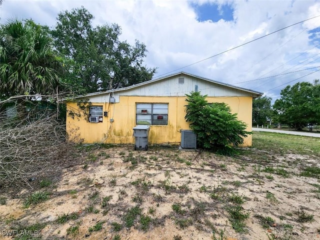 view of side of home featuring central AC unit