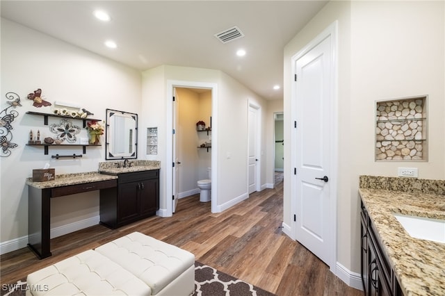 bathroom featuring hardwood / wood-style floors, vanity, and toilet