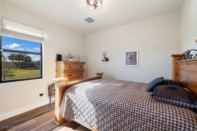 bedroom with hardwood / wood-style floors