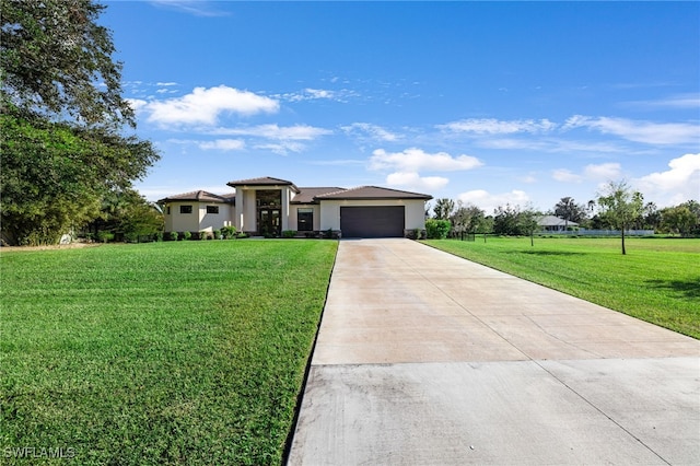 view of front of house featuring a garage and a front lawn