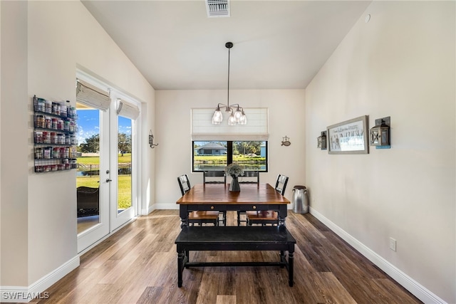 dining area with a chandelier, hardwood / wood-style floors, and a healthy amount of sunlight