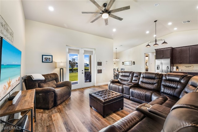 living room with french doors, ceiling fan, dark hardwood / wood-style flooring, and vaulted ceiling