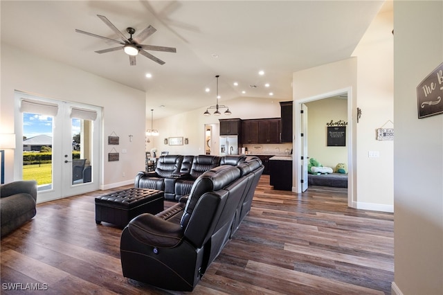 living room with vaulted ceiling, ceiling fan, and dark wood-type flooring