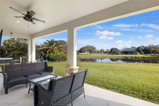 view of patio / terrace with an outdoor living space, ceiling fan, and a water view